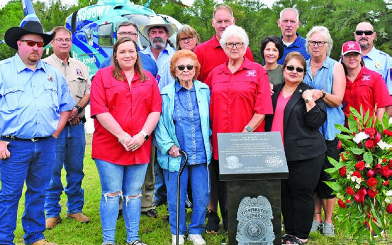 THE SMITH FAMILY, INCLUDING Barbara Smith, Debbie Colley and members of the Deanville Volunteer Fire Department gather around the monument. Also joining them are Paul Luckey of Rockdale Monuments, Wallace Jones, owner of Phillips &amp;amp; Luckey Funeral Home, and Marci Ramirez of Phillips &amp;amp; Luckey Funeral Home.