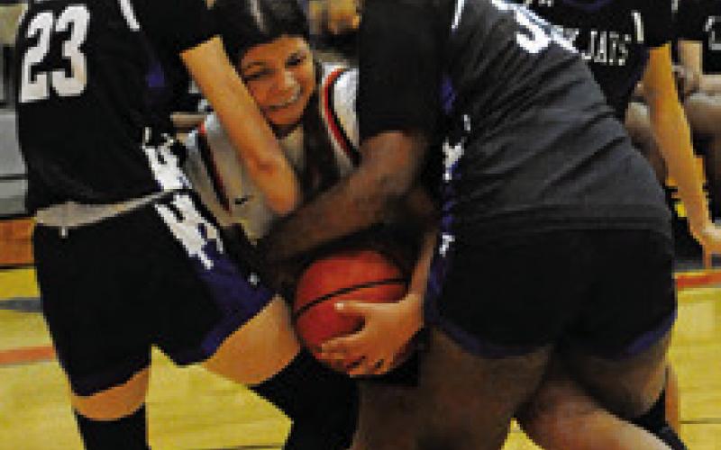 SOMEVILLE’S CAPRI Alejandro fights with Snook’s Dakota Kienow and Jai’Nylah Curry for possession of the ball last Tuesday. Tribune photo by Denise Squier