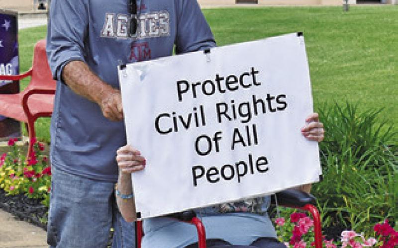 PROTESTERS DISPLAY signs at the No Kings event in Caldwell.