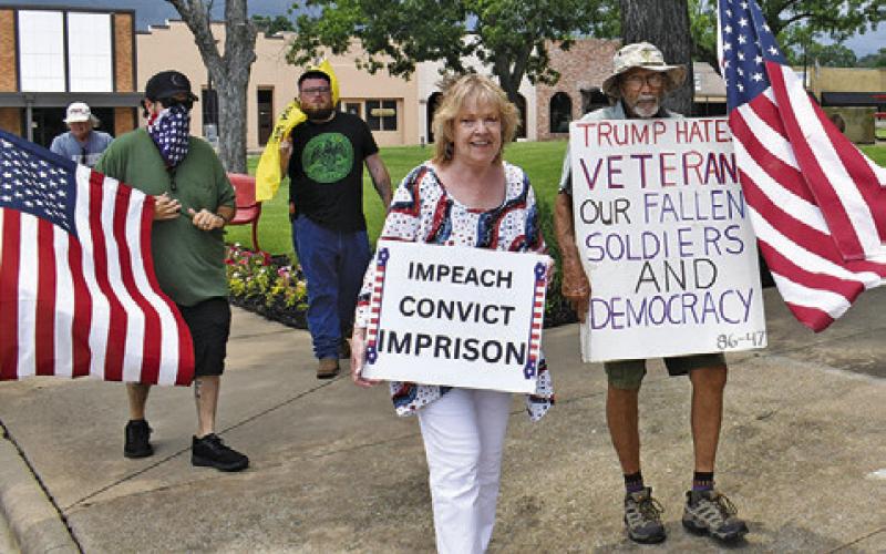PROTESTERS MARCH AROUND the Burleson County Courthouse at the “No Kings” event.
