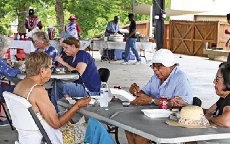 BURLESON COUNTY DEMOCRATS enjoyed a barbecue chicken dinner at their July 4th celebration on Saturday in downtown Caldwell. Tribune photo by Denise Squier