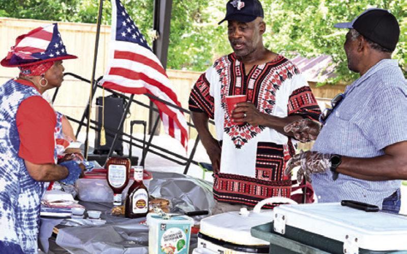 BURLESON COUNTY DEMOCRATS celebrated July 4th at the City of Caldwell’s downtown pavilion by sharing a meal. Tribune photo by Denise Squier