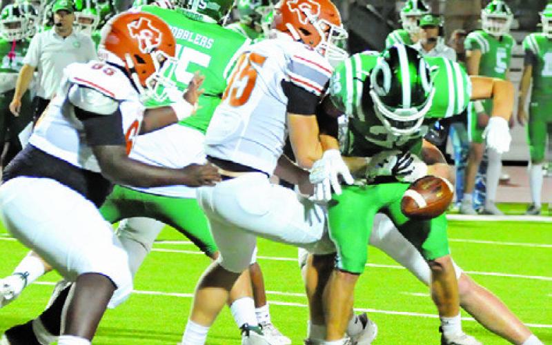 CALDWELL’S CADEN CRUMP and Kayden Robertson defend as this Cuero ball carrier fumbles. -- Tribune photo by Denise Squier