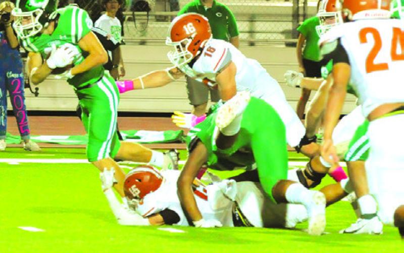 CALDWELL’S JOSH WILSON and Jaxson Anderson defend as this Cuero player breaks for yardage. -- Tribune photo by Denise Squier