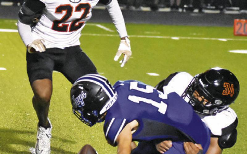 SOMERVILLE’S JAYDEN ESPINOSA and Semaj Pennygraph move in to tackle Snook’s Braedyn Fannin as the ball comes loose. Tribune photo by Roy Sanders