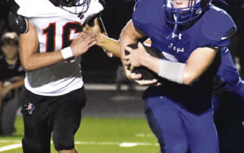 MICHAEL EATON of Snook carries the ball as Somerville’s Brandon Bryant defends.