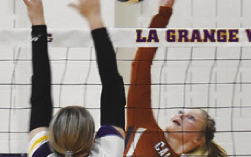 REESE MCMANUS hits the ball over La Grange’s Kenna Lamza. Tribune photo by Roy Sanders