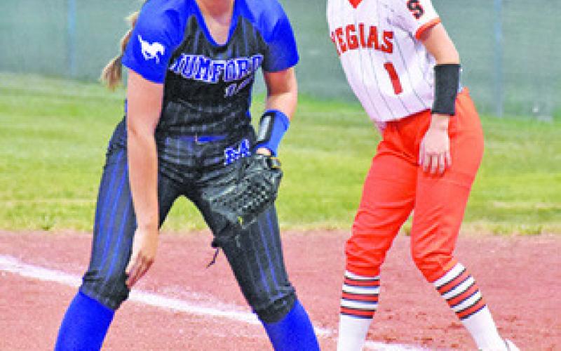 CAYLA BALANGA watches the Mumford pitcher while at first. -- Tribune photo by Roy Sanders