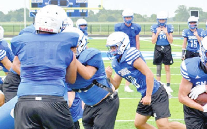 FULLBACK GARRETT HYVL carries the ball after a handoff from quarterback Garrett Lero during Snook’s practice session. Snook is getting ready for the 2021 season. -- Tribune photo by Roy Sanders