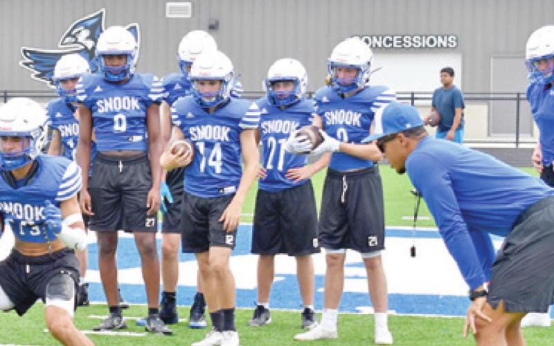 SNOOK ASSISTANT COACH Eriq Mitchell observes this drill. Pictured are Jose Garcia, Lanca Lara, Mark Moore, Riley Pitts, Garrett Hyvl and Ryder Becka. -- Tribune photo by Roy Sanders