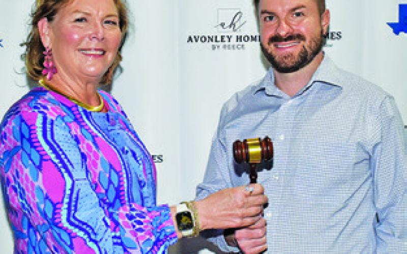 DONNA SCHOENEMANN passes the gave to new chamber chair Stu Chapman.