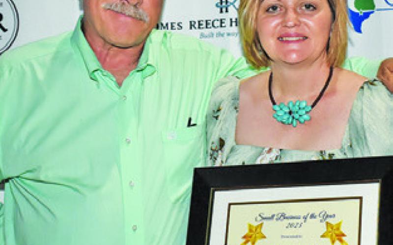 PHIL AND SHARON Livengood display their award for Small Business of the Year.