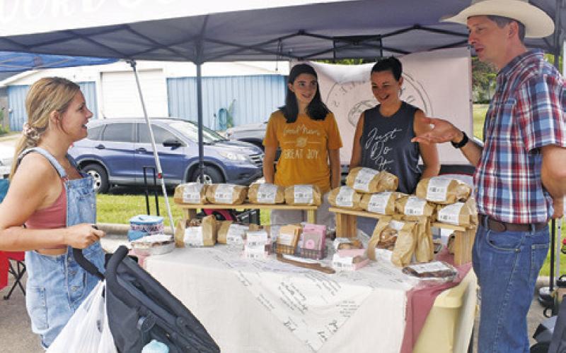 THE SOMERVILLE FARMERS Market draws visitors last Sunday, Sept. 1. Pictured are Sarah Underwood, Joslyn and Dannille Knowlton and Matthew Cavens. Tribune photo by Roy Sanders