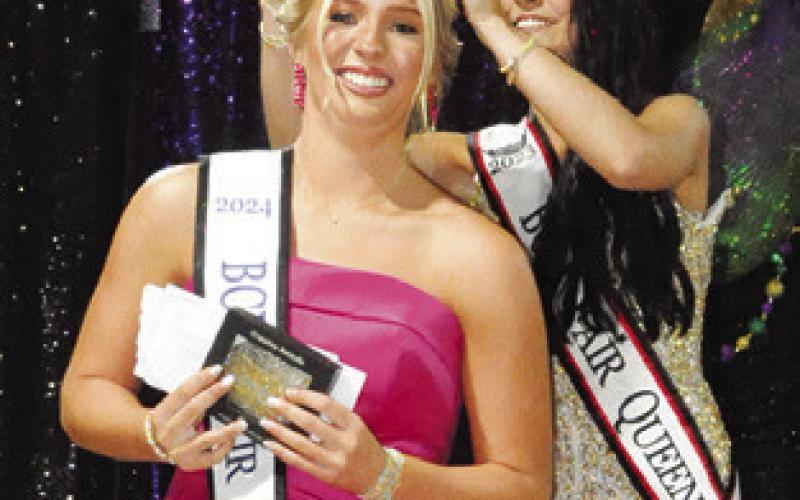 LAST YEAR’S Fair Queen Kate Hill crowns Hadleigh Novosad as the 2024 Burleson County Fair Queen last Tuesday night. Tribune photo by Denise Squier