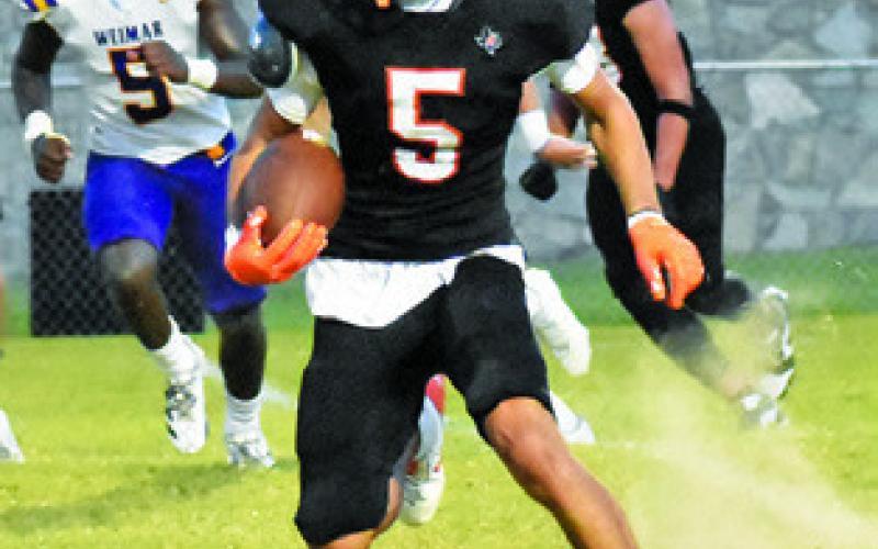 KYLE BROOKS of Somerville carries the ball against Weimar. Tribune photo by Roy Sanders
