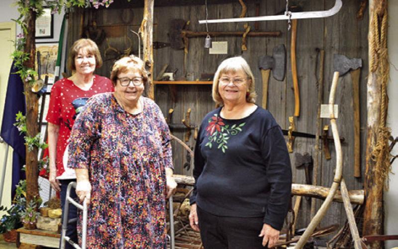 HISTORICAL COMMISSION members Bonnie Blue, Melynda Giesenschlag and Gayla Townsend stand before a museum exhibit during the Burleson County Historical Museum’s open house last Friday in the Burleson County Courthouse. See story inside. Tribune photo by Sabine Lazo