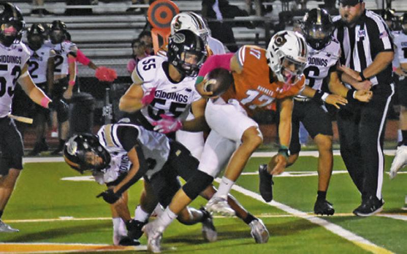 QUARTERBACK KORBIN BURNS carries for Caldwell against Giddings. The Hornets won 44-14 in their district opener. Tribune photo by Roy Sanders