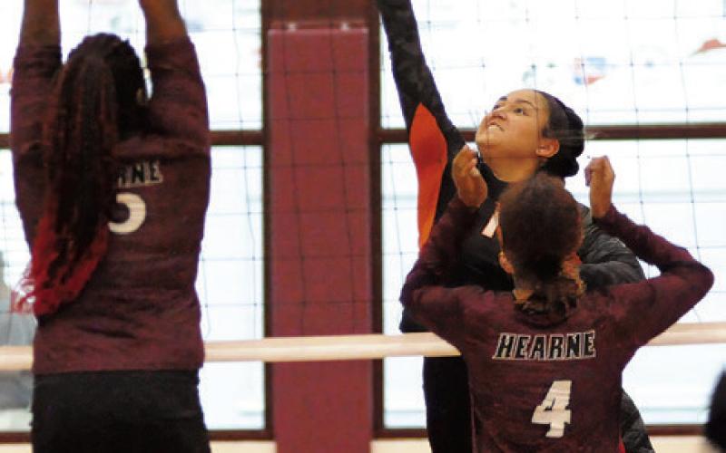 SOMERVILLE’S VIVIANNA MUNOZ muscles the ball past a Hearne blocker during the Somerville-Hearne match last Friday in Hearne. Tribune photo by Denise Squier