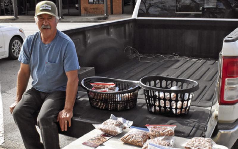BILL REE SELLS pecans on Saturday, Nov. 15, at the Caldwell Farmers Market in downtown Caldwell. The market is held on Saturdays.