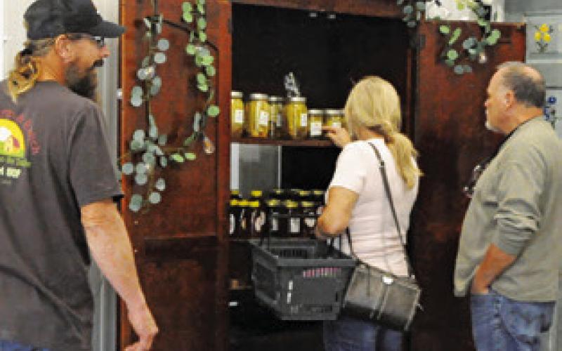 SHOPPERS EXAMINE THE STOREFRONT’S wares at the Boniol Farm and Ranch