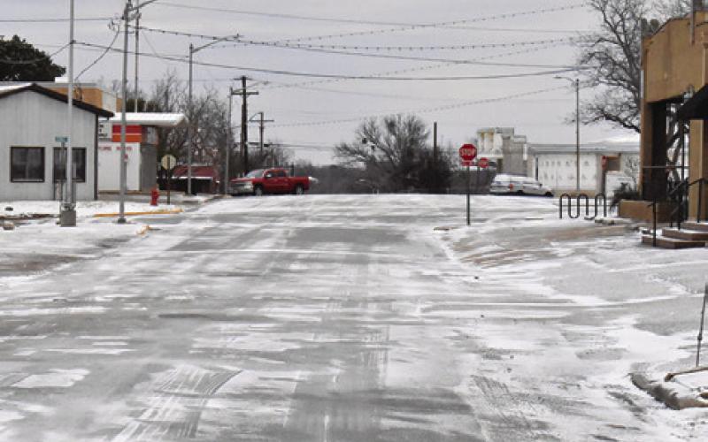 STREETS IN DOWNTOWN CALDWELL were covered in snow after the county received a little under an inch of the white powdery stuff. Tribune photo by Roy Sanders