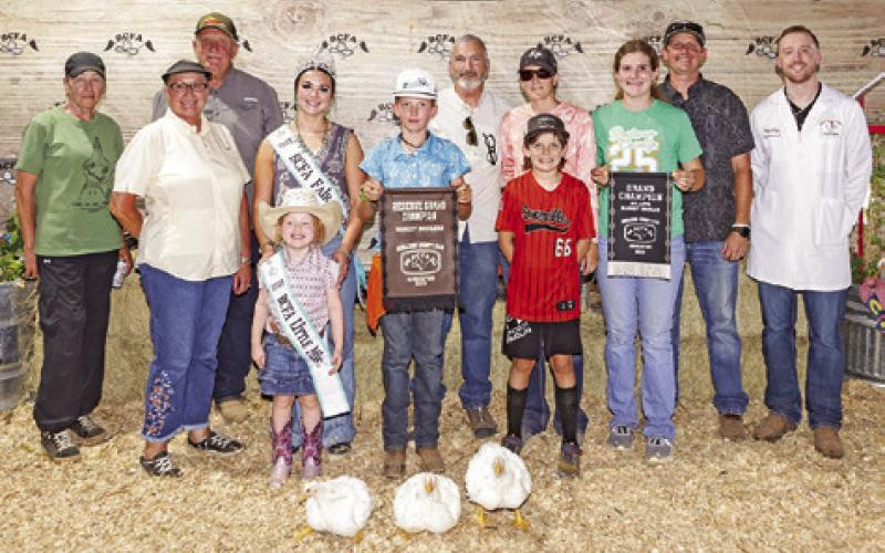 CORBIN NEUENDORFF EXHIBITED THE Reserve Champion Broilers at the 2025 Burleson County Fair. Also pictured are Cooper Neuendorff, Kylie Neuendorff, Jason Neuendorff, Niki Neuendorff, Judge Jacob Price, Burleson County Fair Queen Kodi Hitchcock and Little Miss Taytum Hohlt.