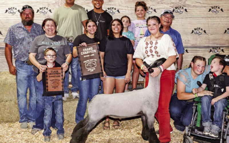 EMILIE LEASURE EXHIBITED the Grand Champion Lamb at the 2025 Burleson County Fair. Also pictured are Charles Lewis, Shanda Lewis, Jordan Maldonado, Rylie Leasure, Frank Maldonado, Cheyenne Lewis, Jackson Maldonado, Omar Carillo, X’Zavion Vela, Grace Martin, Shelby Martin, Burleson County Fair Queen Kodi Hitchcock and Little Miss Taytum Hohlt.
