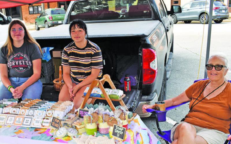 EDNA SCHULZ of Rabbit Hill Farm Soap Creations displays her items for sale on Saturday at the Burleson County Farmers Market.
