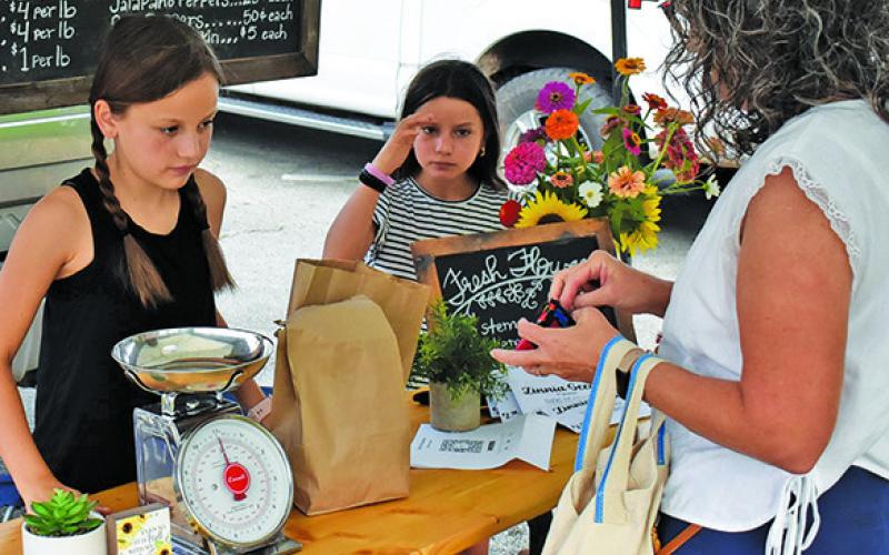 ROOTS &amp;amp; RIBBONS of Caldwell sells their items on Saturday morning at the Burleson County Farmers Market in Caldwell.