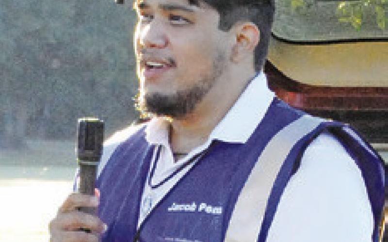 JACOB PENA SPOKE prior to the start of Saturday’s “Debbie’s 5K Color Walk,” hosted by the Pena Brothers Memorial. The organization supports local scholarships, local charities and education to prevent alcohol abuse. Tribune photo by Denise Squier