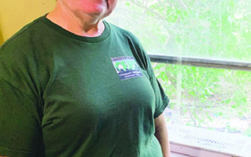 CERT MEMBER Deanie Gold installed a window air conditioning unit in a home in Tunis last weekend. CERT is raising money to install more AC units into homes needing cooling.