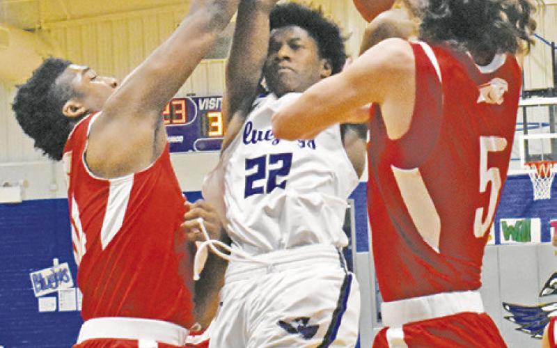 JIMMY KEARNEY FACES heavy defensive pressure from Burton as he takes this shot. -- Tribune photo by Roy Sanders