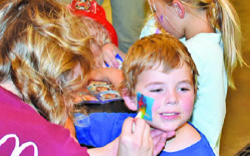 A CHILD ENJOYS face painting at the Caldwell National Night Out celebration on Oct. 7 at the Caldwell Fire Station.