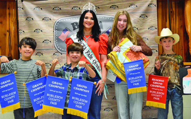 DALLAS AND ADRIAN SANCHEZ won grand in Children’s Corner Photography and Creative Arts, Sawyer Vann won grand in First Time Quilts and Kolton Willard was reserve in Junior Art. Also pictured is Fair Queen Kodi Hitchcock. Tribune photo by Sabine Lazo