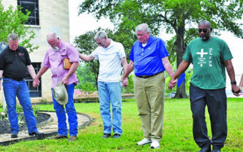 LOCAL PASTORS PRAY on Thursday, May 1, at National Day of Prayer at the Burleson County Courthouse. They include, from left, Joe Emerson, Caldwell Brethren Church, Mark Neumann, Elizabeth Lutheran Church, Bill Kristof, Burleson County Cowboy Church, Tim Lee, Providence Baptist Church, David Johnson, New Tabor Brethren Church, Thurman Sims, Immanuel Christian Fellowship, and Dewitt Steyn, Restoration Church.