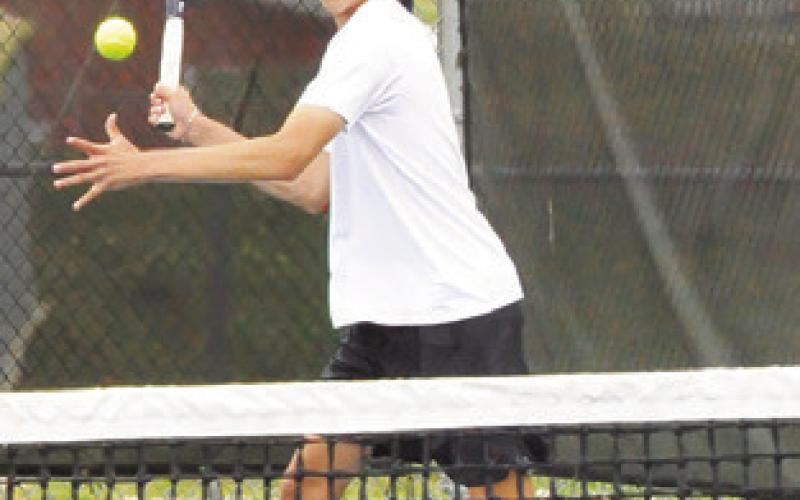 TY BREITSCHOPF sets to return the ball during a mixed doubles match last week at the District 22-4A Tournament in Caldwell.