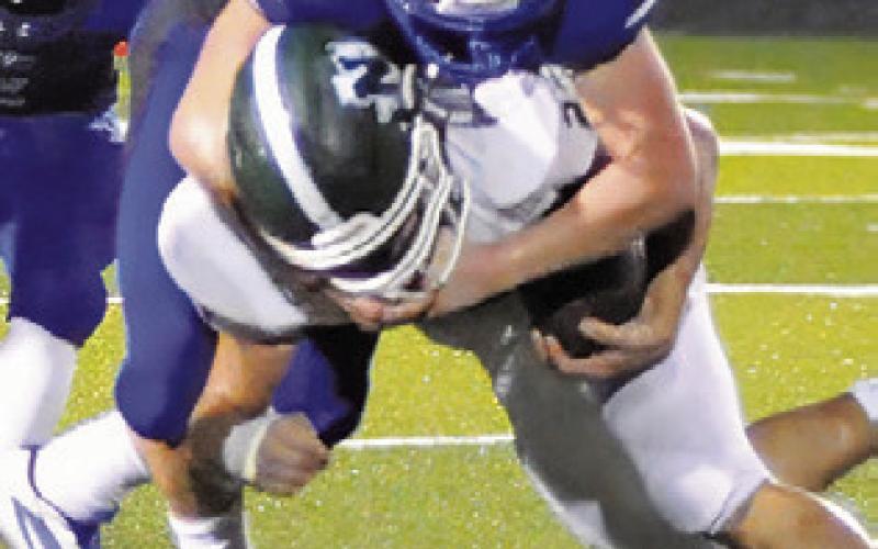 MICHAEL EATON makes a tackle for Snook as teammate Tristan Yen moves in to assist. Tribune photo by Denise Squier