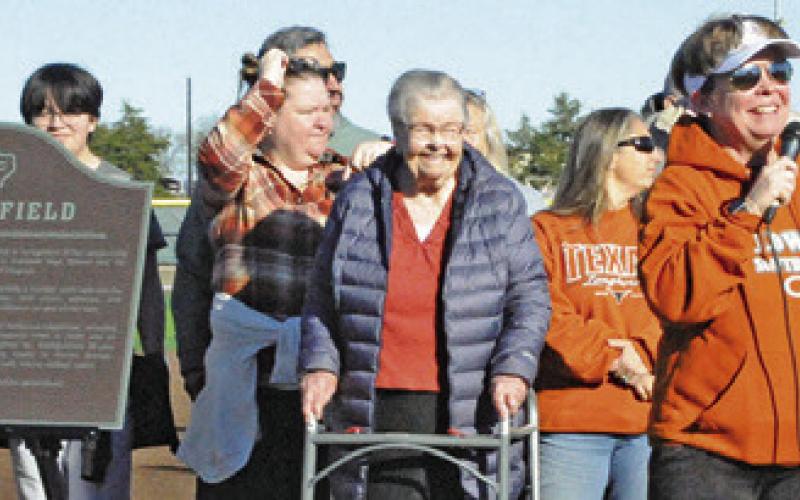 LONGTIME LADY HORNET softball coach Wendy Weiss thanks the community for honoring her by renaming the softball field “Weiss Field.” Her family also attended the ceremony. Tribune photo by Denise Squier