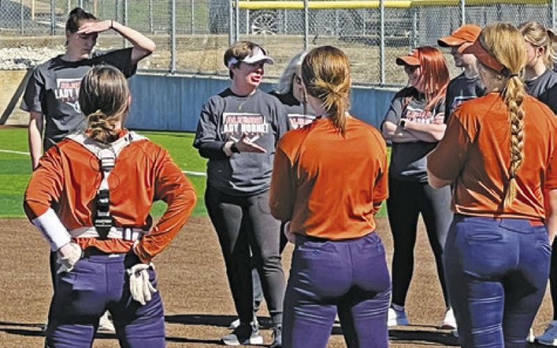 FORMER SOFTBALL COACH Wendy Weiss addresses the current Lady Hornet team and 33 former Lady Hornets after the alumni softball game Saturday at Weiss Field in Caldwell. Tribune photo by Denise Squier