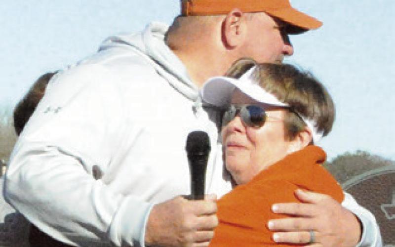 ATHLETIC DIRECTOR Sean Witherwax hugs former coach Wendy Weiss at the ceremony dedicating the softball field to her. Tribune photo by Denise Squier