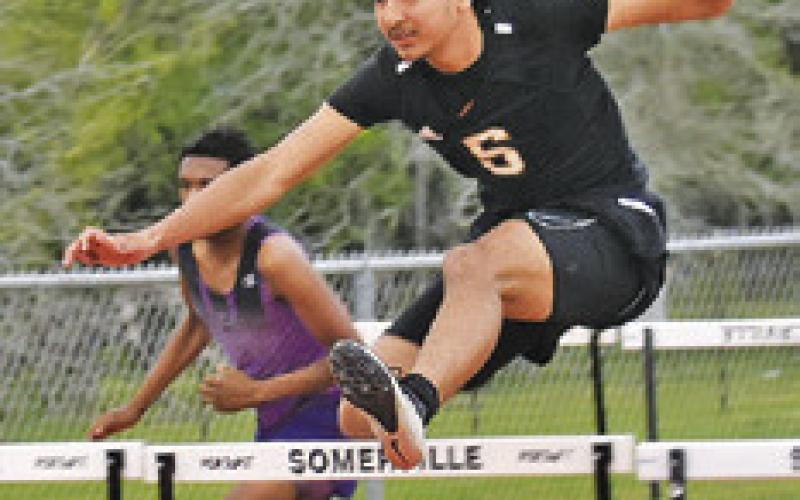 GARDNER SHIVERS jumps over this hurdle during the Koppers Relays last week.