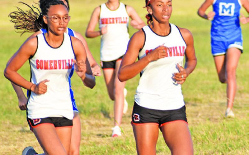 SOMERVILLE’S DESTINY VELA and Ra’Maya Carter run during the varsity girls’ race at last Thursday’s District 26-2A Cross Country Meet.