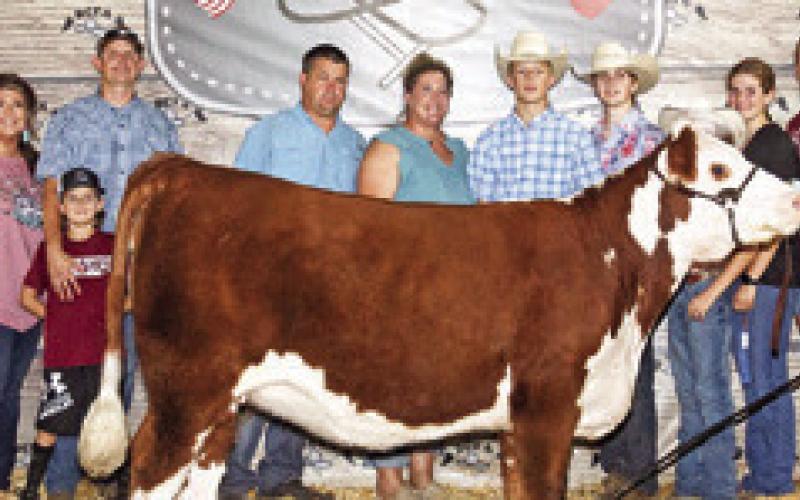 BRAXTON LOCKHART EXHIBITED the Grand Champion breeding heifer at this year’s Burleson County Fair. He is pictured with Dwuane Lockhart, JoAn Lockhart, Wade Shackleford, Mariah Sandner, Cooper Neuendorff, Jason Neuendorff, Tim Lockhart, Erin Lockhart, Aubrey Lockhart, Trevor Lockhart, Corbin Neuendorff, Kiley Neuendorff, Anne Lockhart, Davy Lockhart, Fair Queen Kate Hill, Little Miss Sawyer Sandner, Devon Lockhart.