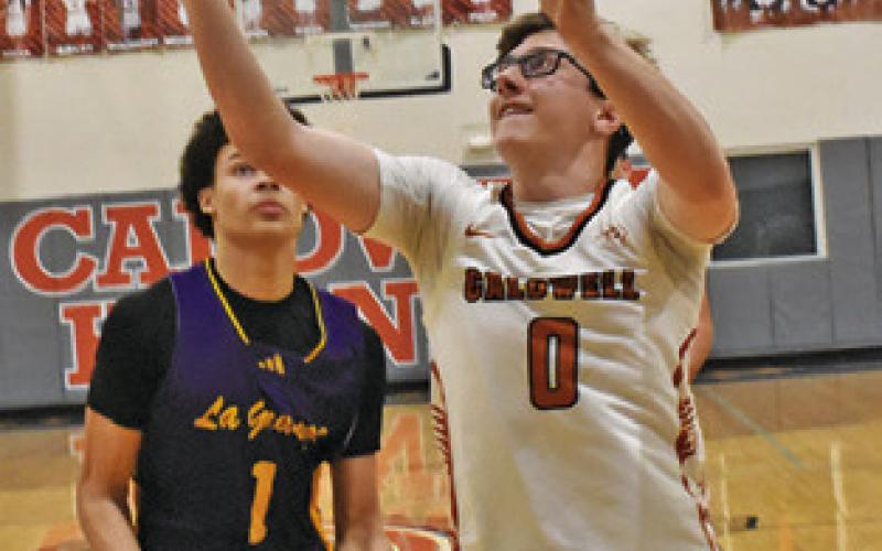 CAYDEN ZBORIL reaches for the ball last Friday against La Grange. Tribune photo by Roy Sanders