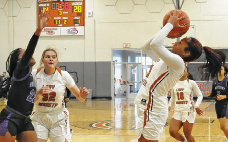 CALDWELL’S AVELYNN O’RILEY shoots over a Waco University defender during their game last Monday at Hornet Gym. Tribune photo by Denise Squier