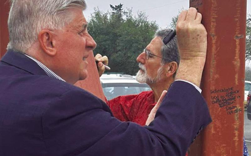 MEMBERS OF NEW Tabor Brethren Church wrote scriptures on the frames of the new building last Sunday.