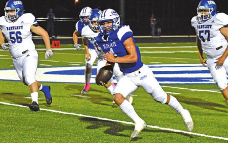 GARRETT LERO CARRIES the ball against Bartlett. The Snook Bluejays won 56-8. -- Tribune photo by Roy Sanders