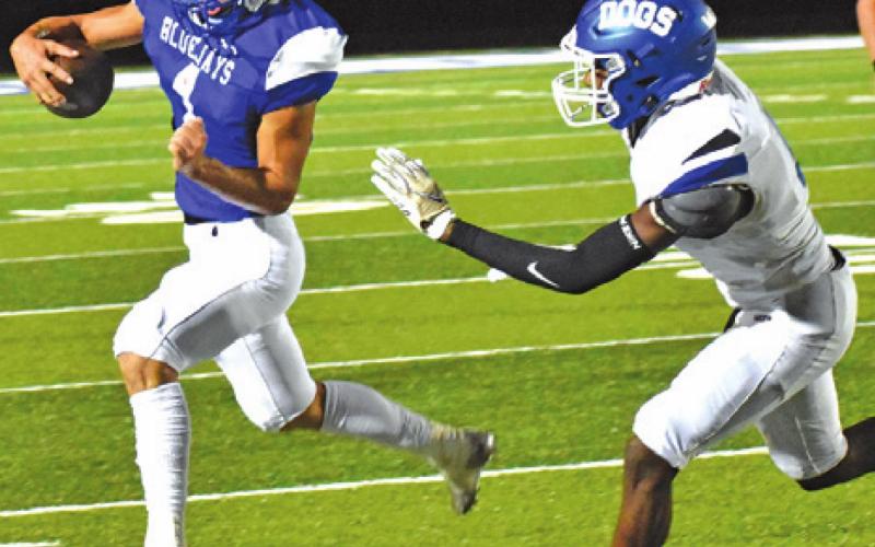SNOOK’S GARRETT LERO heads for the sideline as this Bartlett player approaches. -- Tribune photo by Roy Sanders