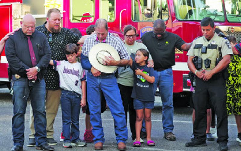 MANY COMMUNITY MEMBERS AND members of Caldwell Methodist Church prayed for area first responders and over their vehicles last Wednesday for Patriots Day. Photo courtesy of Steve Ingram