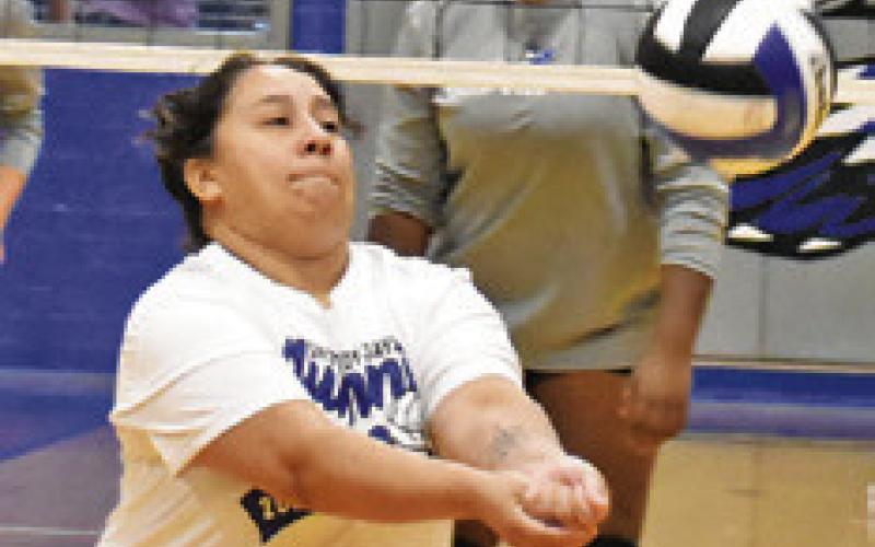 TRYING TO KEEP THE ball in play was a goal of the Snook volleyball alumni last week against the current squad. Tribune photo by Roy Sanders